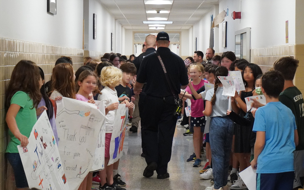 students line hallway to high-five ems